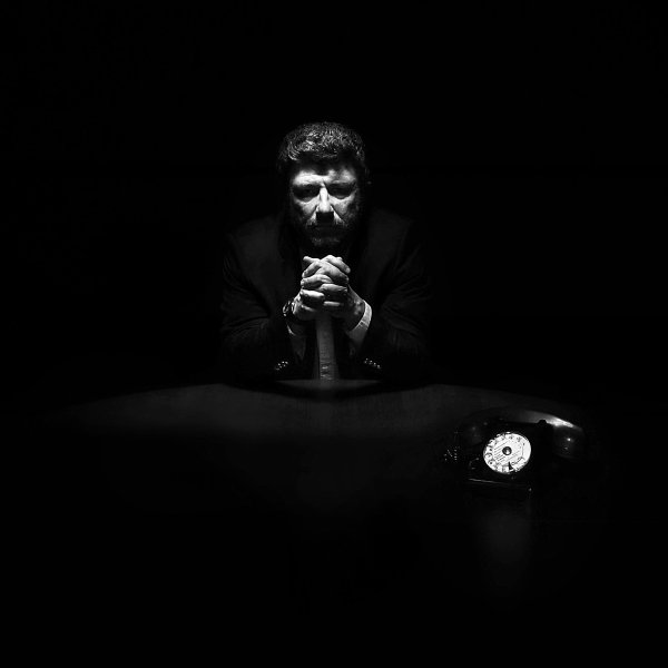Un homme dans le noir les mains jointes